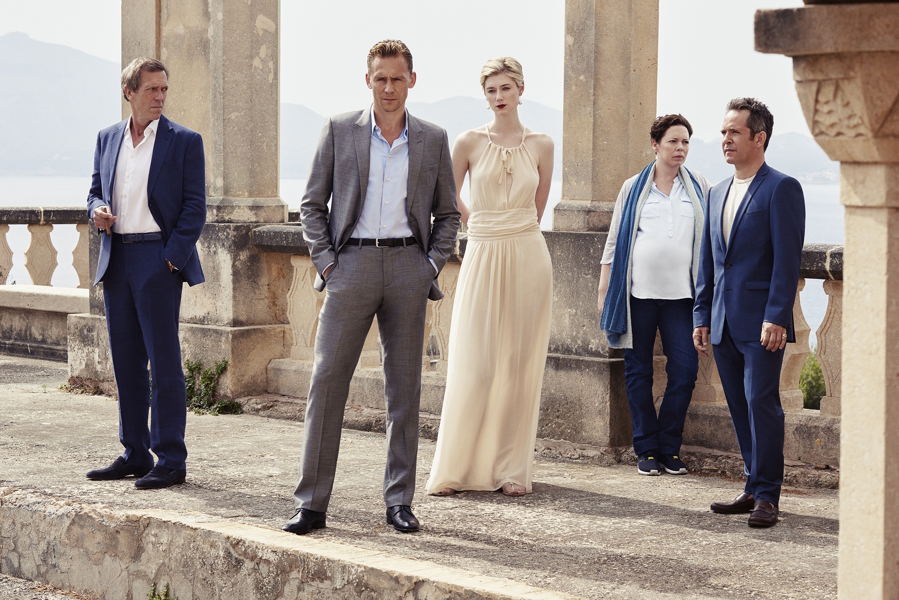 Tom Hiddleston as Jonathan Pine, Tom Hollander as Major Corkoran, Elizabeth Debicki as Jed Marshall, Olivia Colman as Angela Burr, and Hugh Laurie as Richard Roper - The Night Manager _ Season 1, Gallery - Photo Credit: Mitch Jenkins/The Ink Factory/AMC