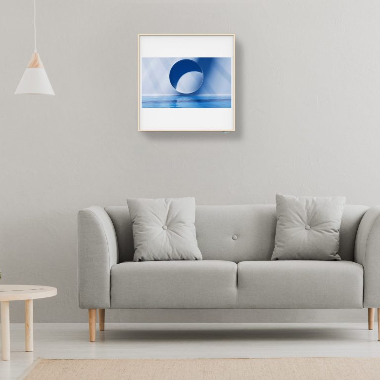 Green plant on a scandinavian cabinet with drawer and a cozy couch with pillows in a gray, simple living room interior with place for a coffee table. Real photo.