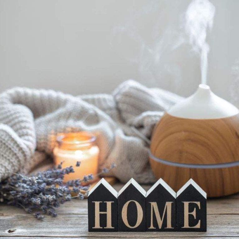 aroma-still-life-with-modern-aroma-oil-diffuser-wooden-surface-with-knitted-element-cozy-details-decorative-word-home
