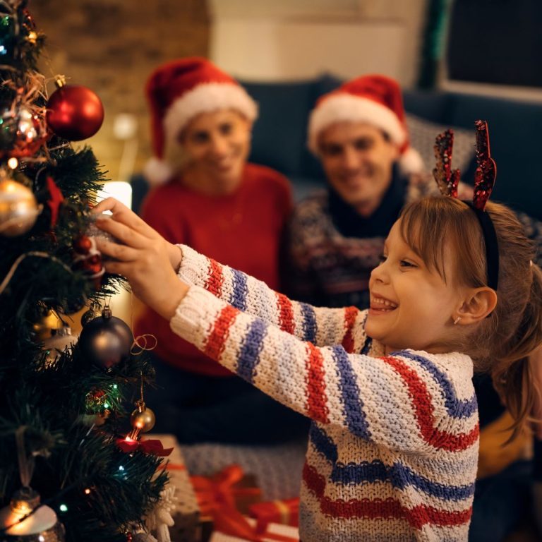 happy-small-girl-decorating-christmas-tree-evening-home