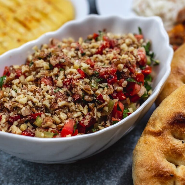 side-view-walnut-salad-with-tomato-cucumber-greens-bread-table_141793-5161