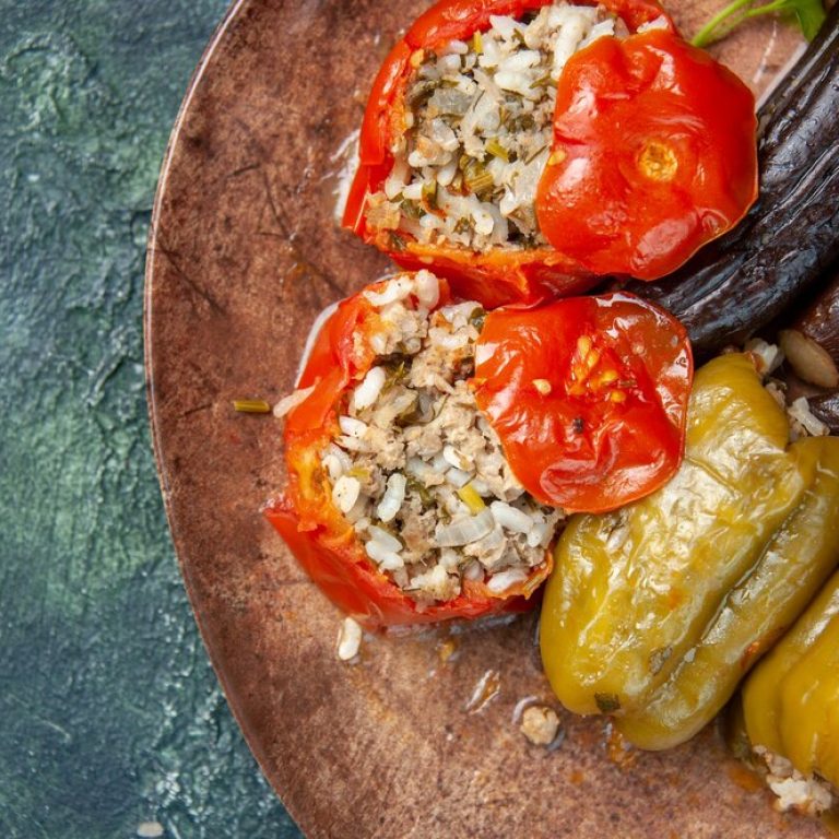 top-close-view-delicious-vegetable-dolma-meal-filled-with-ground-meat-blue-background_179666-17238