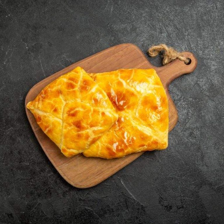 top-view-pies-board-two-pies-wooden-kitchen-board-center-table